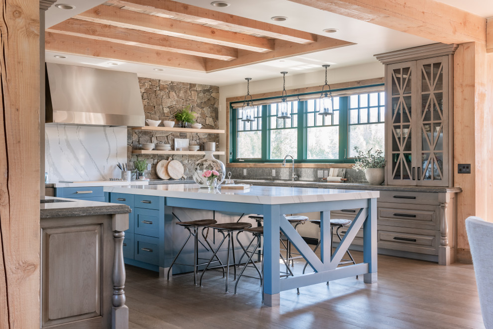 Large rustic u-shaped kitchen/diner in Other with flat-panel cabinets, medium wood cabinets, stainless steel appliances, light hardwood flooring and an island.