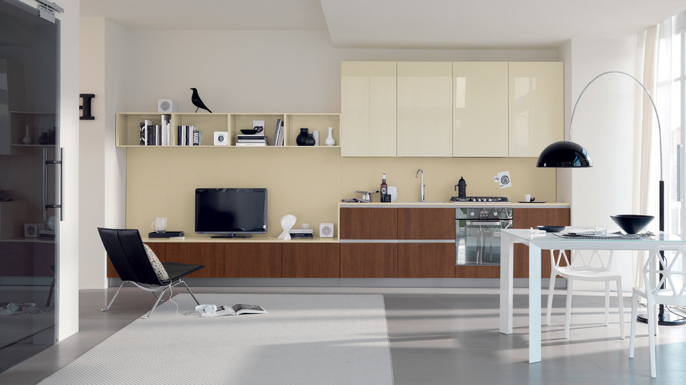 Example of a small minimalist single-wall porcelain tile eat-in kitchen design in Melbourne with a single-bowl sink, raised-panel cabinets, beige cabinets, quartzite countertops, black backsplash, glass sheet backsplash, paneled appliances and two islands
