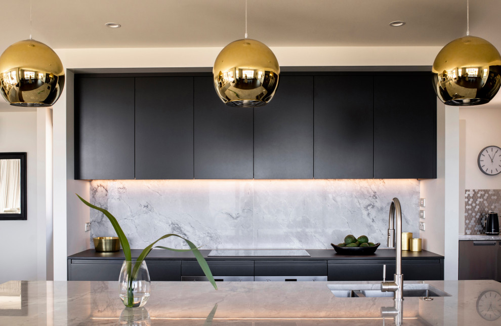 Photo of a medium sized contemporary l-shaped kitchen/diner in Napier-Hastings with a double-bowl sink, flat-panel cabinets, grey cabinets, quartz worktops, grey splashback, marble splashback, stainless steel appliances, dark hardwood flooring, an island, brown floors and grey worktops.