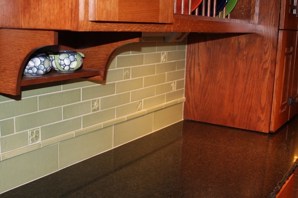 Example of a mid-sized arts and crafts u-shaped ceramic tile open concept kitchen design in Seattle with an undermount sink, shaker cabinets, medium tone wood cabinets, granite countertops, green backsplash, ceramic backsplash, stainless steel appliances and an island
