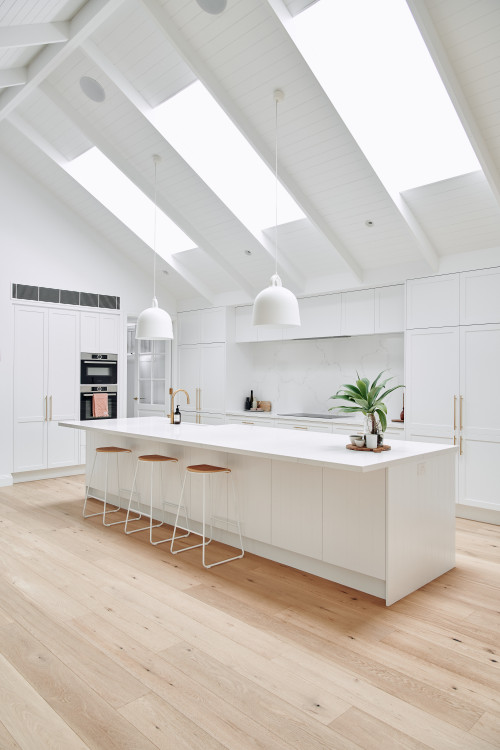 High Ceiling Delight: White Farmhouse Kitchen with Shiplap Ceiling and Skylights