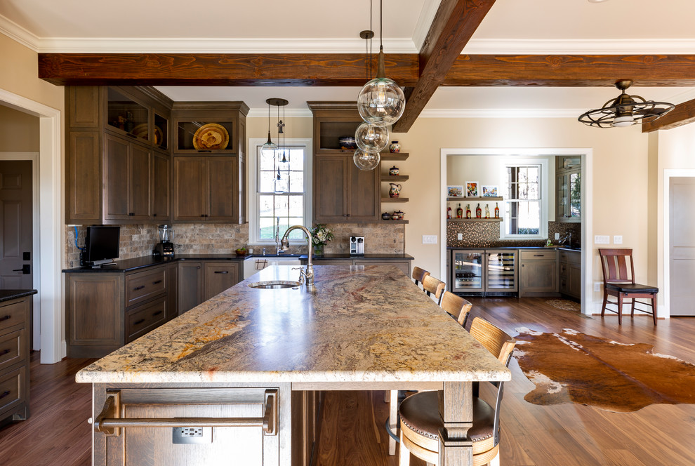 Kitchen - rustic medium tone wood floor and brown floor kitchen idea in Charlotte with a farmhouse sink, medium tone wood cabinets, granite countertops, multicolored backsplash, stone tile backsplash, stainless steel appliances, an island and black countertops