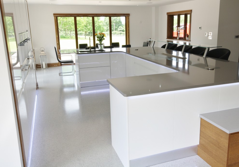 Inspiration for a modern kitchen in Essex with an island.