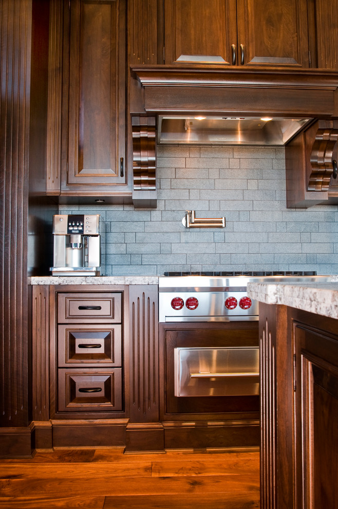 Example of a classic eat-in kitchen design in Vancouver with beaded inset cabinets, medium tone wood cabinets, granite countertops, stone tile backsplash and stainless steel appliances
