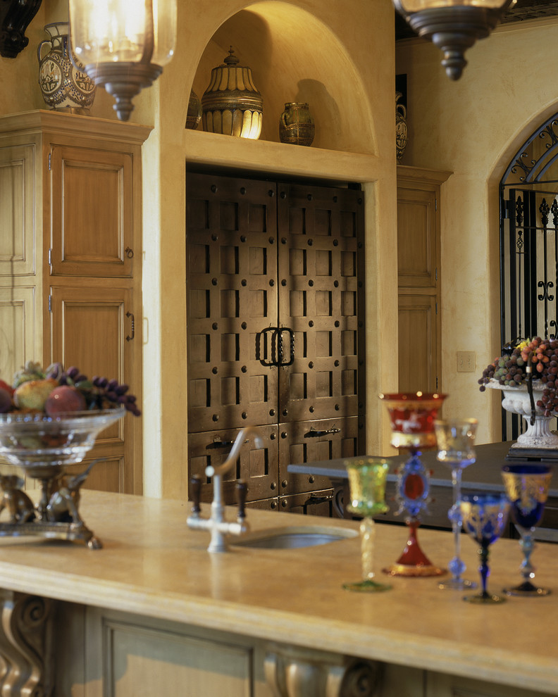 Example of a large tuscan u-shaped eat-in kitchen design in New York with an undermount sink, beaded inset cabinets, distressed cabinets, limestone countertops, beige backsplash, ceramic backsplash, stainless steel appliances and an island