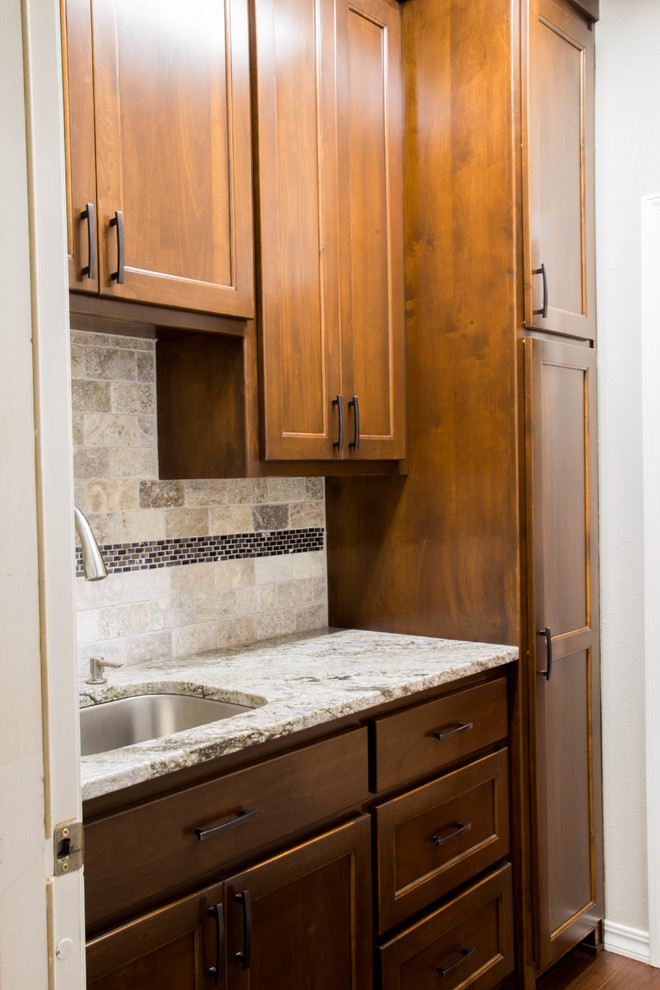 Example of a mid-sized minimalist medium tone wood floor and brown floor eat-in kitchen design in Other with an undermount sink, flat-panel cabinets, brown cabinets, granite countertops, gray backsplash, travertine backsplash, stainless steel appliances and gray countertops
