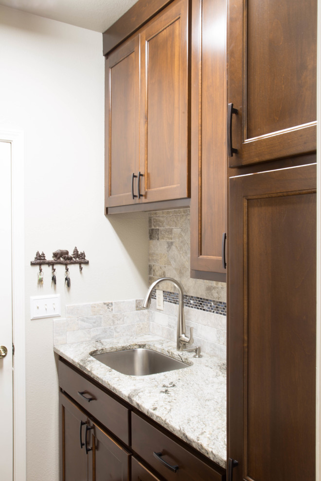 Mid-sized minimalist medium tone wood floor and brown floor eat-in kitchen photo in Other with an undermount sink, flat-panel cabinets, brown cabinets, granite countertops, gray backsplash, travertine backsplash, stainless steel appliances and gray countertops