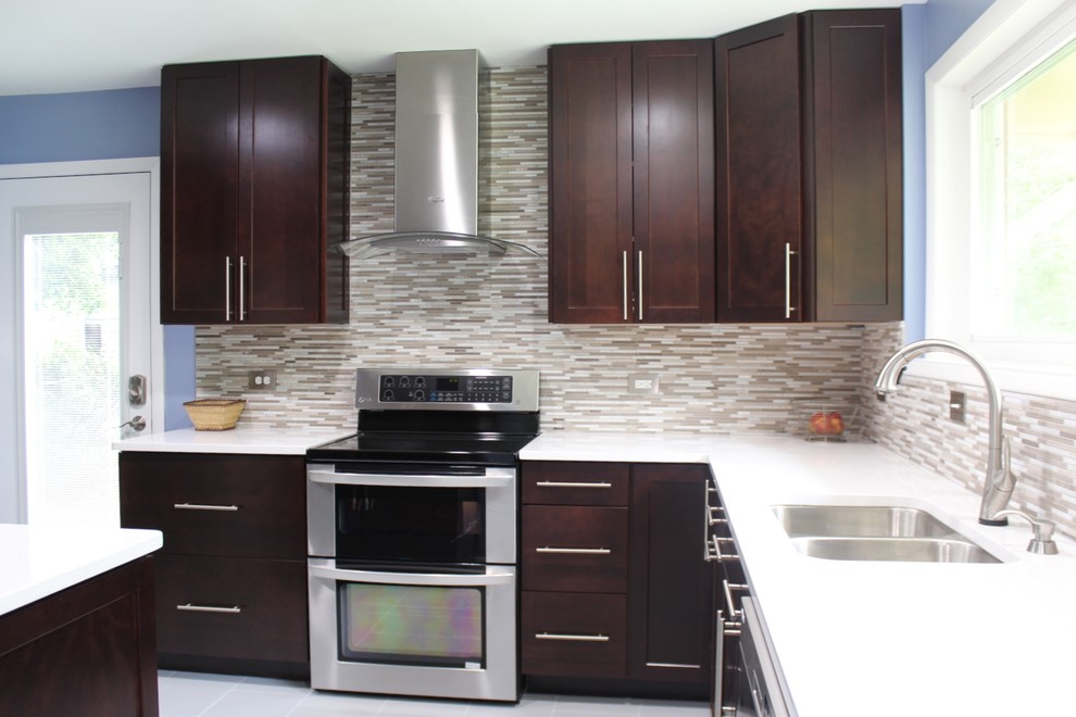 Mid-sized trendy l-shaped porcelain tile and white floor eat-in kitchen photo in Houston with a double-bowl sink, shaker cabinets, dark wood cabinets, solid surface countertops, multicolored backsplash, stainless steel appliances, matchstick tile backsplash and an island