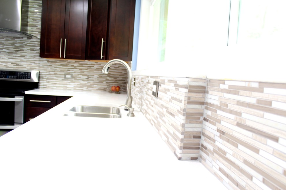 Example of a mid-sized trendy l-shaped porcelain tile and white floor eat-in kitchen design in Houston with a double-bowl sink, shaker cabinets, dark wood cabinets, solid surface countertops, multicolored backsplash, stainless steel appliances, matchstick tile backsplash and an island