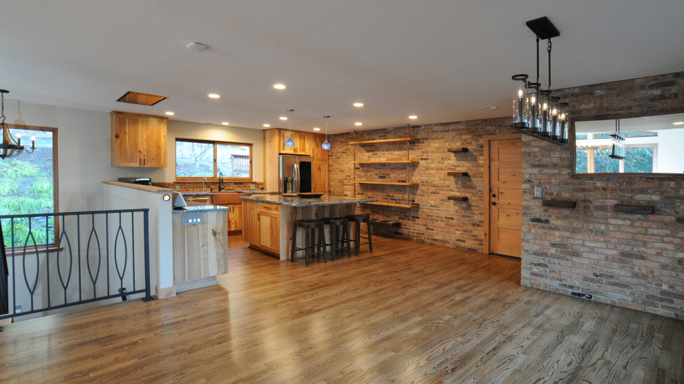 Exempel på ett stort rustikt blå blått kök, med en rustik diskho, skåp i shakerstil, skåp i ljust trä, granitbänkskiva, brunt stänkskydd, stänkskydd i tegel, rostfria vitvaror, mörkt trägolv, en köksö och brunt golv