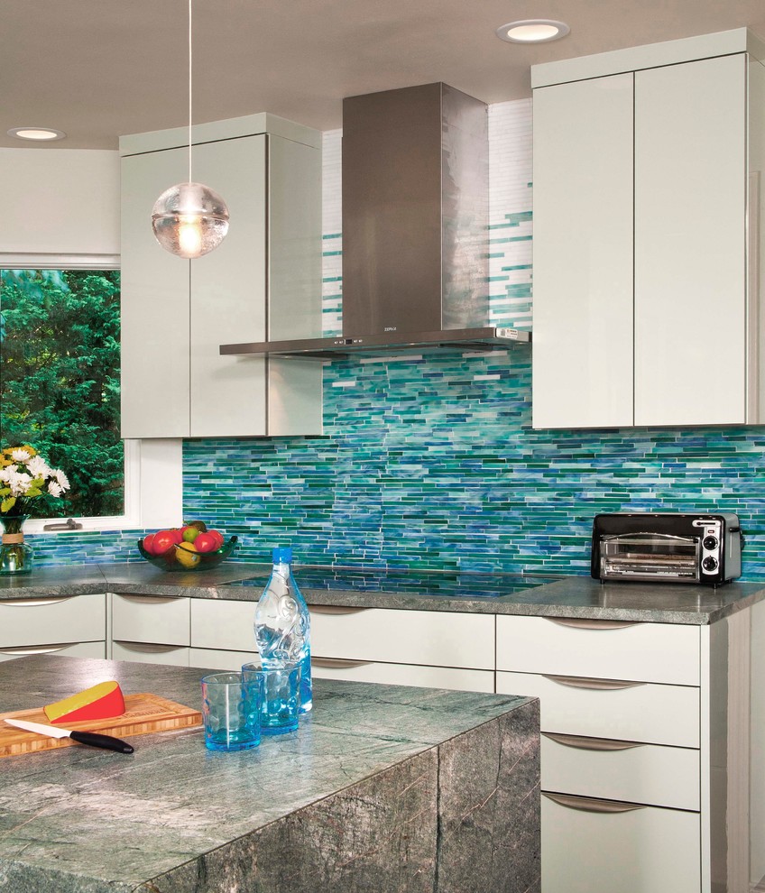 Large trendy dark wood floor kitchen photo in Seattle with green backsplash, matchstick tile backsplash, an undermount sink, flat-panel cabinets, green cabinets, granite countertops, stainless steel appliances and an island
