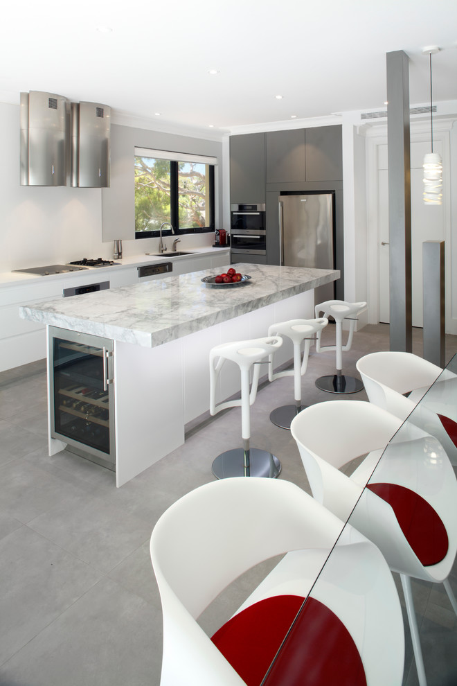 Esempio di una cucina minimal di medie dimensioni con lavello sottopiano, ante lisce, ante bianche, top in granito, paraspruzzi bianco, paraspruzzi con lastra di vetro e elettrodomestici in acciaio inossidabile