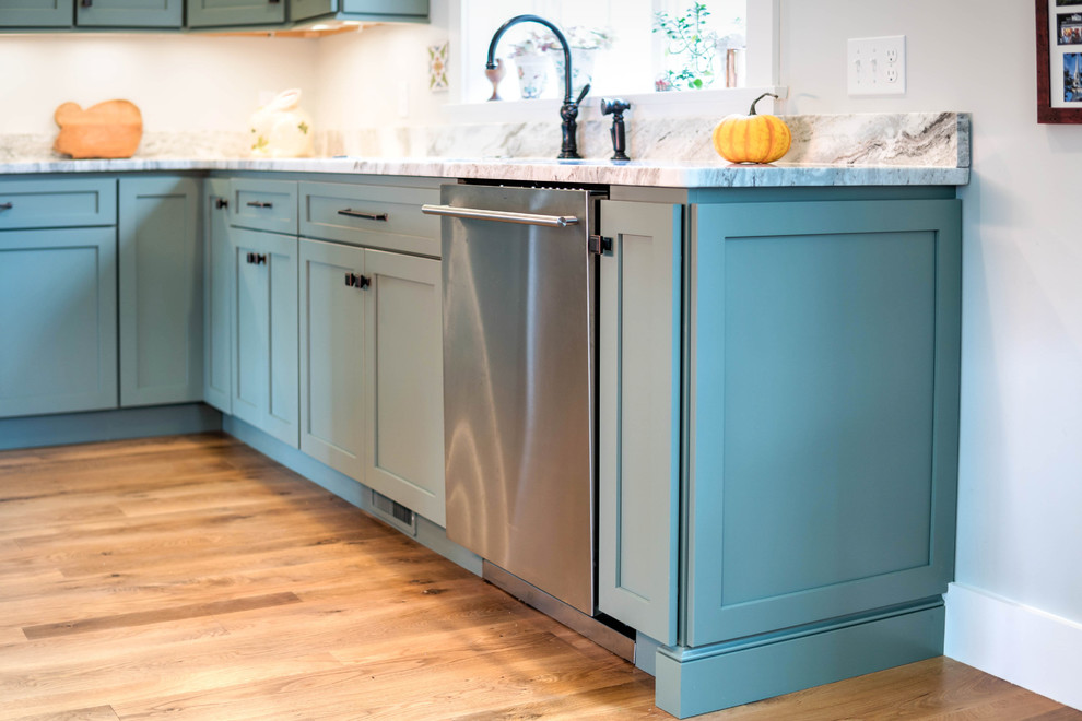 Example of a mid-sized eclectic l-shaped light wood floor and brown floor eat-in kitchen design in Boston with an undermount sink, shaker cabinets, gray cabinets, wood countertops, gray backsplash, metal backsplash, stainless steel appliances and an island