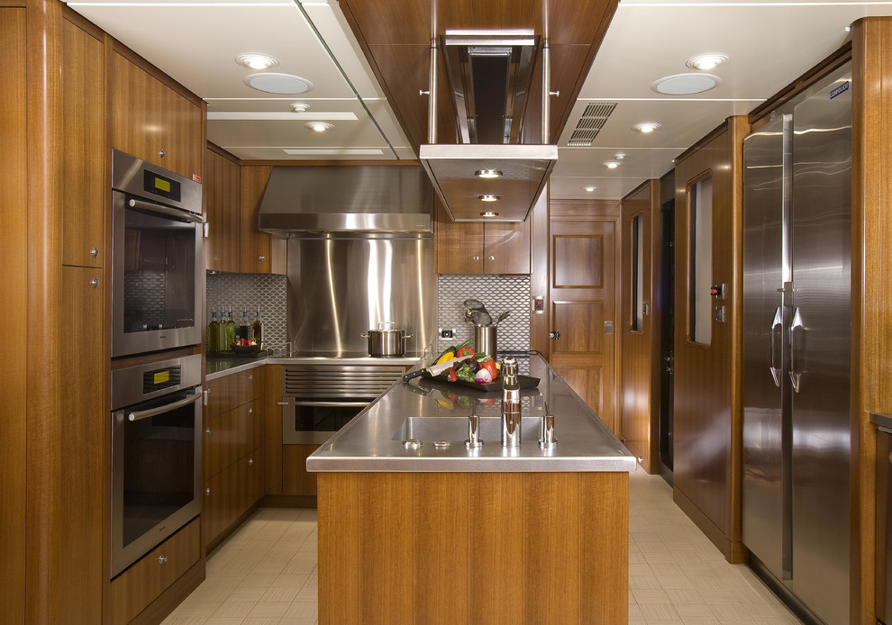 Photo of a traditional l-shaped enclosed kitchen in Seattle with flat-panel cabinets, medium wood cabinets and stainless steel worktops.
