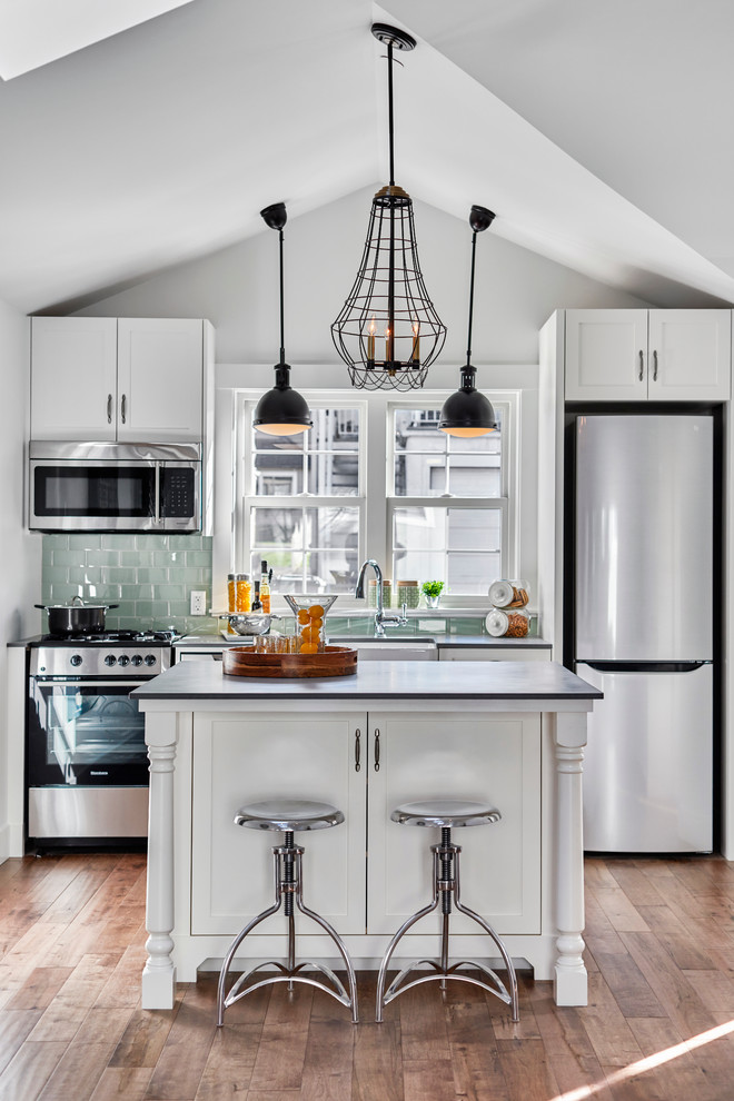 Small transitional kitchen photo in Vancouver with green backsplash and an island