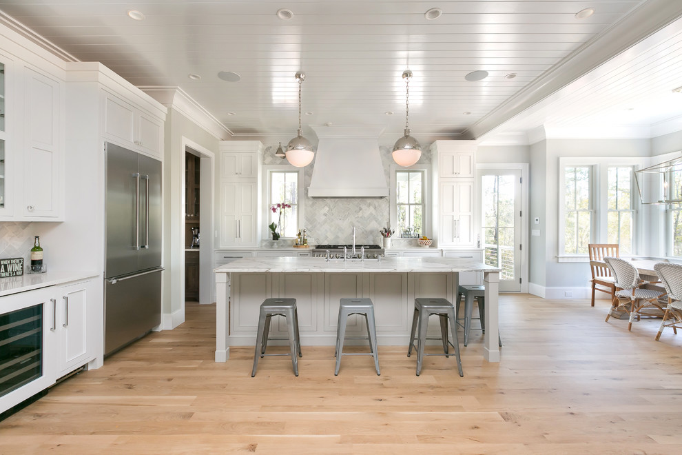Exempel på ett stort maritimt kök, med ljust trägolv, en köksö, en rustik diskho, skåp i shakerstil, vita skåp, marmorbänkskiva, flerfärgad stänkskydd, stänkskydd i marmor, rostfria vitvaror och beiget golv
