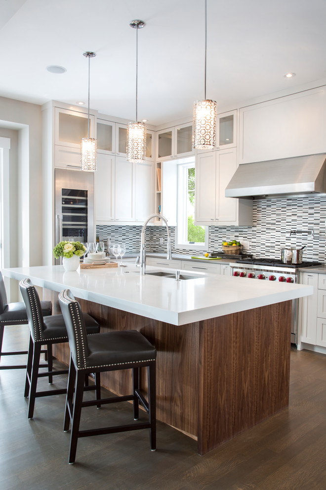 Inspiration for a transitional l-shaped dark wood floor open concept kitchen remodel in Calgary with an undermount sink, shaker cabinets, white cabinets, quartz countertops, multicolored backsplash, matchstick tile backsplash, stainless steel appliances and an island