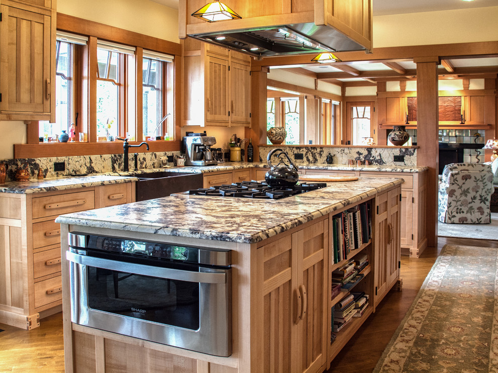 Example of a large mountain style u-shaped eat-in kitchen design in Portland Maine with a farmhouse sink, laminate countertops, black backsplash, stone slab backsplash and two islands