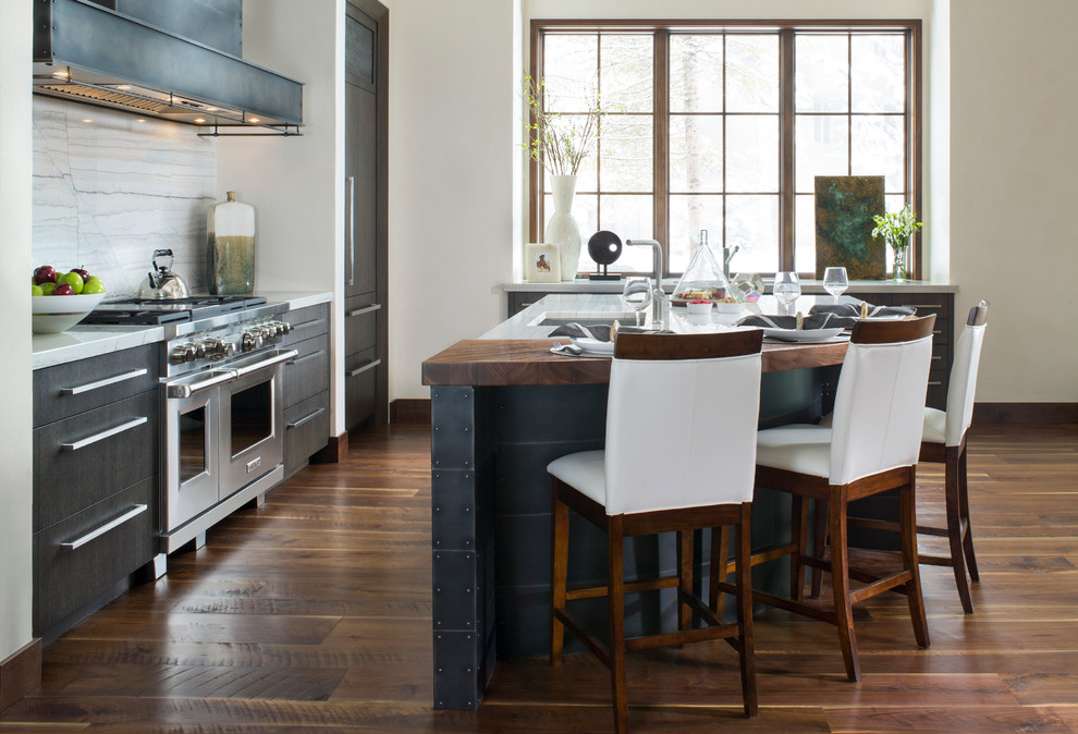 Inspiration for a traditional kitchen in Denver with a submerged sink, flat-panel cabinets, dark wood cabinets, multi-coloured splashback, stone slab splashback, stainless steel appliances, an island and dark hardwood flooring.