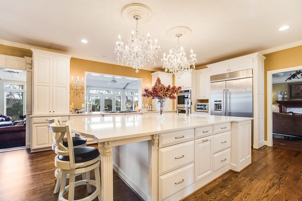 Inspiration for a large traditional l-shaped kitchen/diner in Birmingham with raised-panel cabinets, white cabinets, engineered stone countertops, stainless steel appliances and an island.