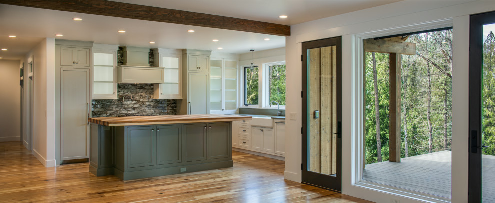 Eat-in kitchen - mid-sized contemporary l-shaped medium tone wood floor eat-in kitchen idea in Seattle with a farmhouse sink, shaker cabinets, gray cabinets, quartz countertops, gray backsplash, porcelain backsplash, paneled appliances, an island and green countertops
