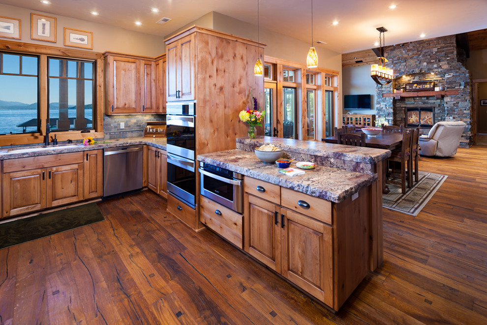 Inspiration för mellanstora rustika flerfärgat kök, med en undermonterad diskho, luckor med upphöjd panel, skåp i ljust trä, granitbänkskiva, grått stänkskydd, stänkskydd i stenkakel, rostfria vitvaror, mellanmörkt trägolv och brunt golv