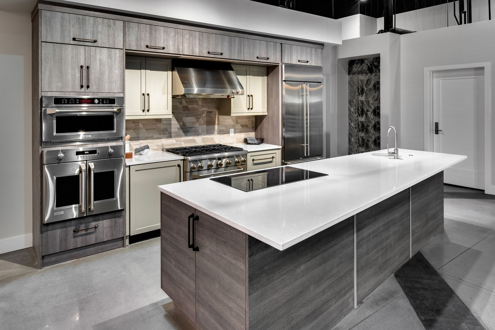 Mid-sized minimalist single-wall laminate floor and gray floor enclosed kitchen photo in Boise with an undermount sink, flat-panel cabinets, gray cabinets, quartz countertops, multicolored backsplash, ceramic backsplash, stainless steel appliances, an island and white countertops