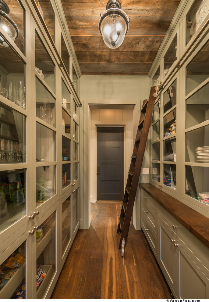 Photo of a large contemporary galley kitchen pantry in San Francisco with glass-front cabinets, grey cabinets, medium hardwood flooring, a belfast sink, marble worktops, white splashback, ceramic splashback, integrated appliances and no island.