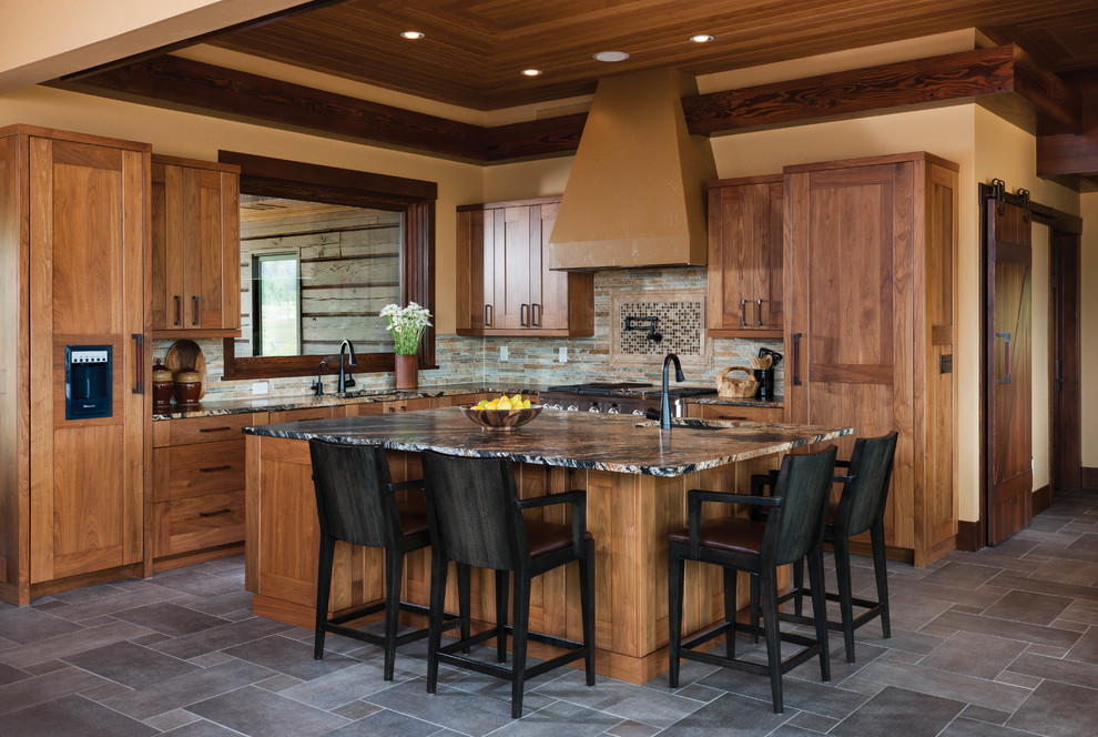 Example of a mid-sized minimalist l-shaped slate floor open concept kitchen design in Boise with recessed-panel cabinets, light wood cabinets, granite countertops, multicolored backsplash, stone tile backsplash, stainless steel appliances and an island