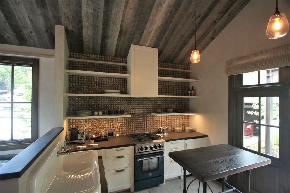 Open concept kitchen - small craftsman l-shaped concrete floor open concept kitchen idea in Denver with an integrated sink, shaker cabinets, white cabinets, black appliances, an island, concrete countertops, multicolored backsplash and mosaic tile backsplash