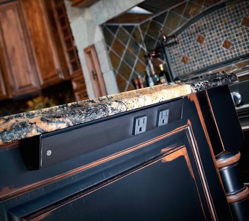 Photo of a large rustic single-wall kitchen/diner in Other with a submerged sink, raised-panel cabinets, black cabinets, terrazzo worktops, cement tile splashback, light hardwood flooring, multi-coloured splashback, stainless steel appliances, an island and brown floors.