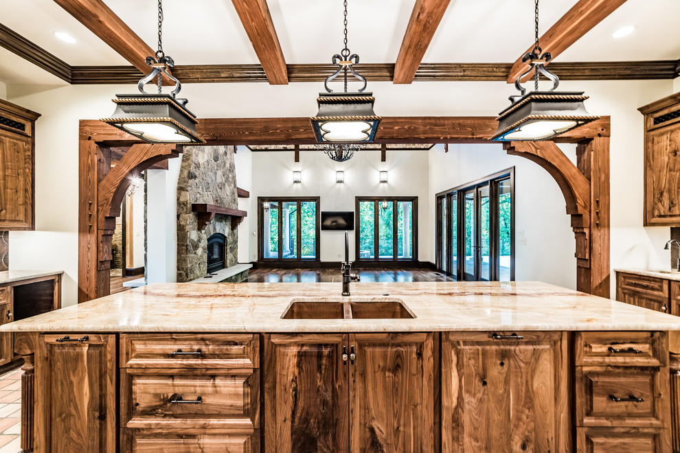 Inspiration for a large rustic u-shaped terra-cotta tile and multicolored floor eat-in kitchen remodel in Other with an undermount sink, raised-panel cabinets, dark wood cabinets, onyx countertops, brown backsplash, terra-cotta backsplash, stainless steel appliances, an island and beige countertops