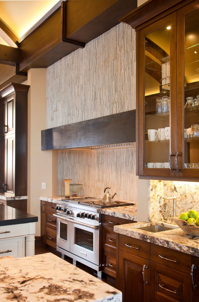 Inspiration for a rustic kitchen in Salt Lake City with a submerged sink, raised-panel cabinets, dark wood cabinets and stainless steel appliances.