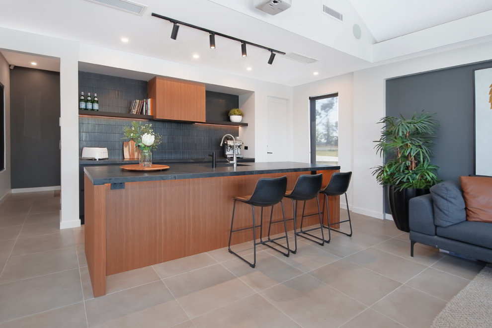 Eat-in kitchen - mid-sized modern galley cement tile floor and beige floor eat-in kitchen idea in Sydney with a double-bowl sink, flat-panel cabinets, brown cabinets, granite countertops, black backsplash, ceramic backsplash, black appliances, an island and black countertops