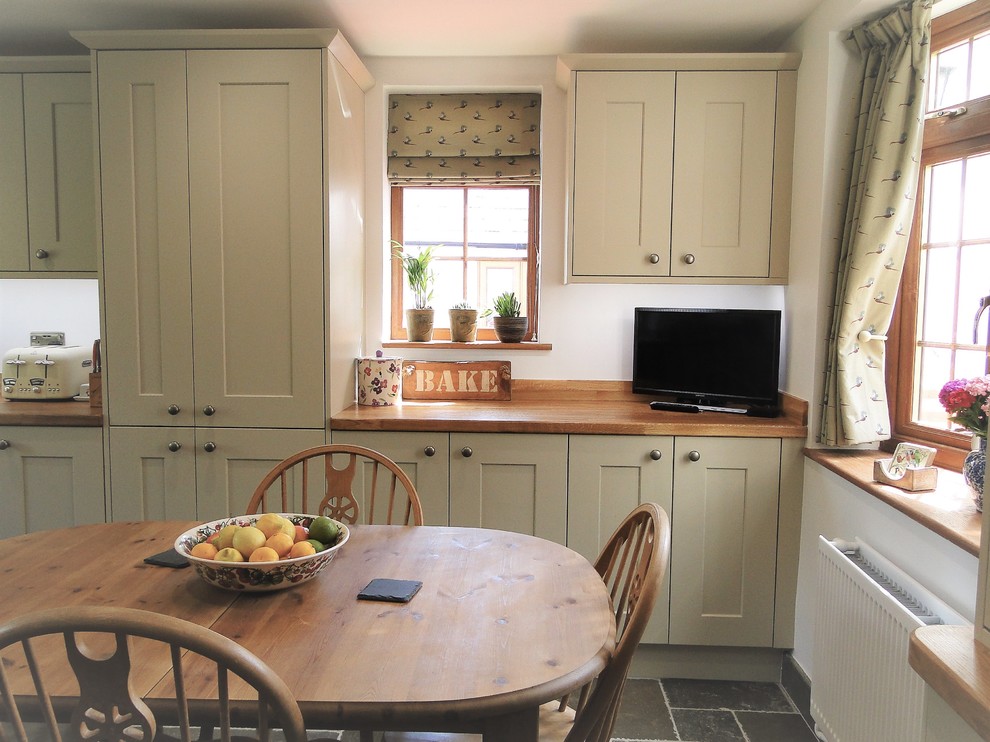 Design ideas for a medium sized classic u-shaped enclosed kitchen in Other with shaker cabinets, white cabinets, wood worktops, coloured appliances, limestone flooring, no island, grey floors and brown worktops.