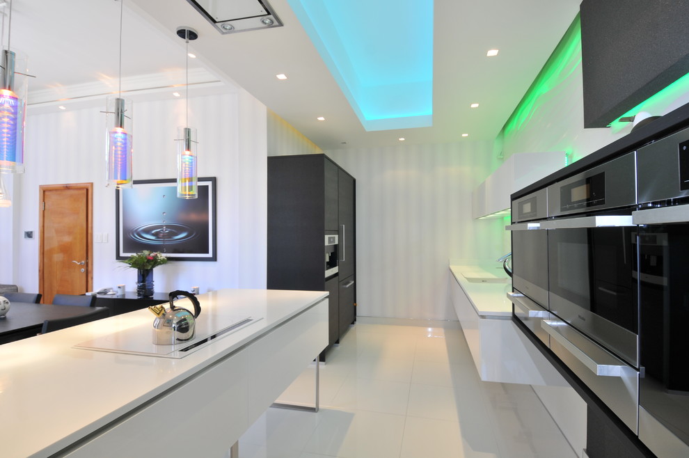 Inspiration for a contemporary kitchen remodel in Manchester with flat-panel cabinets, stainless steel appliances and an island