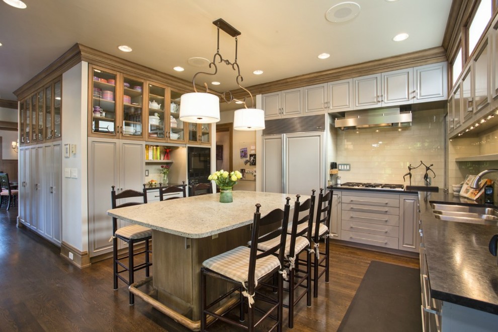 Photo of a traditional u-shaped kitchen in Seattle with raised-panel cabinets and integrated appliances.