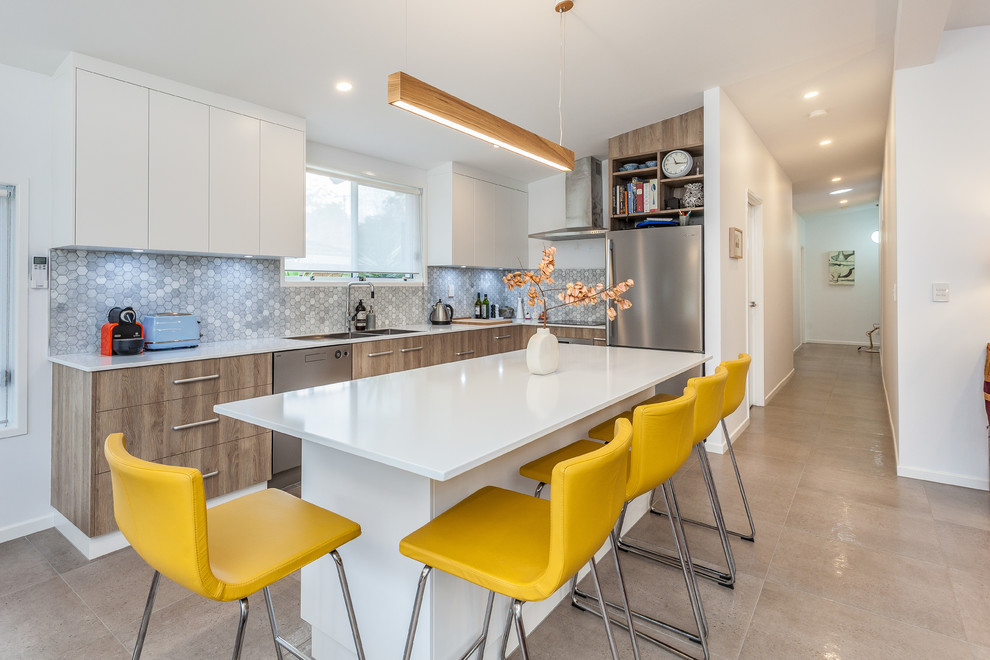 Inspiration for a contemporary l-shaped kitchen remodel in Brisbane with a double-bowl sink, flat-panel cabinets, dark wood cabinets, gray backsplash, mosaic tile backsplash, stainless steel appliances and an island