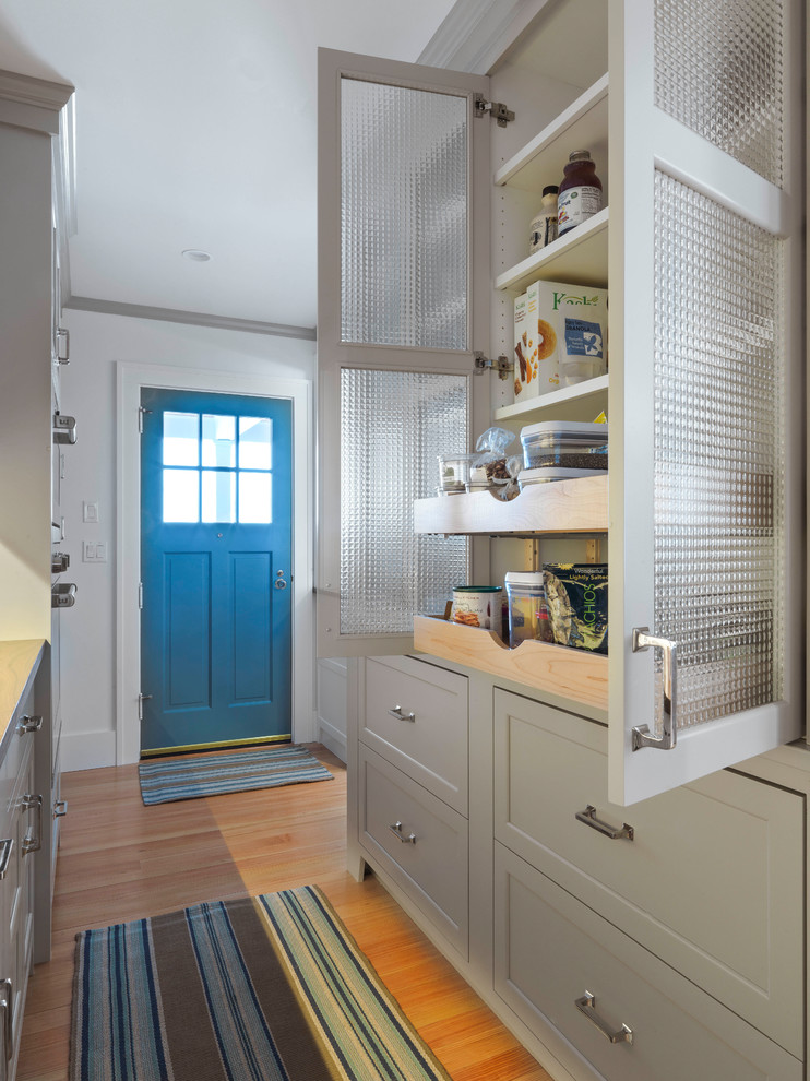 Large arts and crafts kitchen pantry photo in Burlington with recessed-panel cabinets and an island