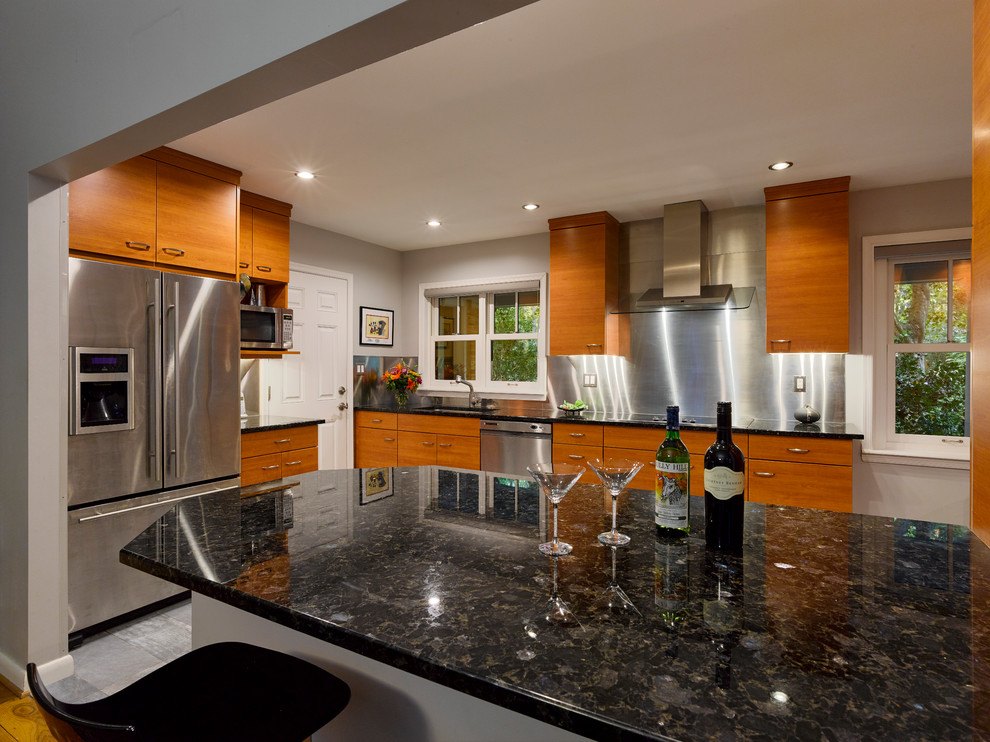 Esempio di una cucina minimalista di medie dimensioni con ante lisce e ante in legno chiaro