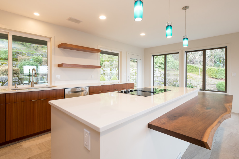 This is an example of a large modern l-shaped kitchen/diner in Portland with a submerged sink, flat-panel cabinets, medium wood cabinets, engineered stone countertops, stainless steel appliances, porcelain flooring and an island.