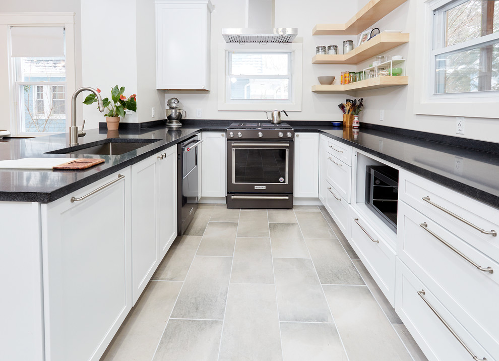 Example of a mid-sized transitional u-shaped ceramic tile and gray floor eat-in kitchen design in Baltimore with an undermount sink, shaker cabinets, white cabinets, granite countertops, white backsplash, window backsplash, stainless steel appliances, a peninsula and black countertops