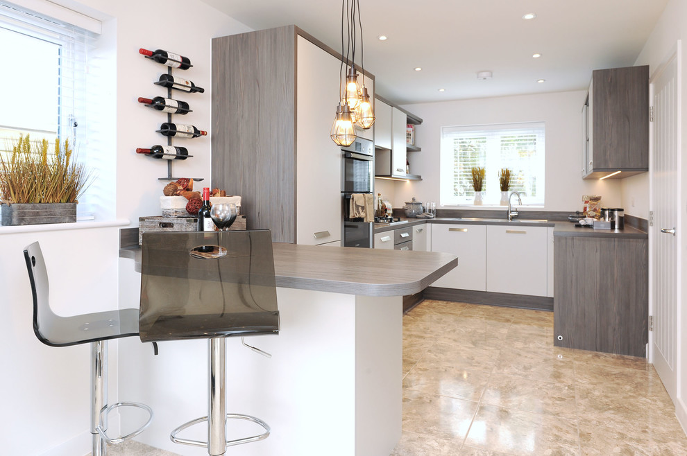Design ideas for a contemporary u-shaped kitchen in Kent with flat-panel cabinets, white cabinets, a breakfast bar and beige floors.