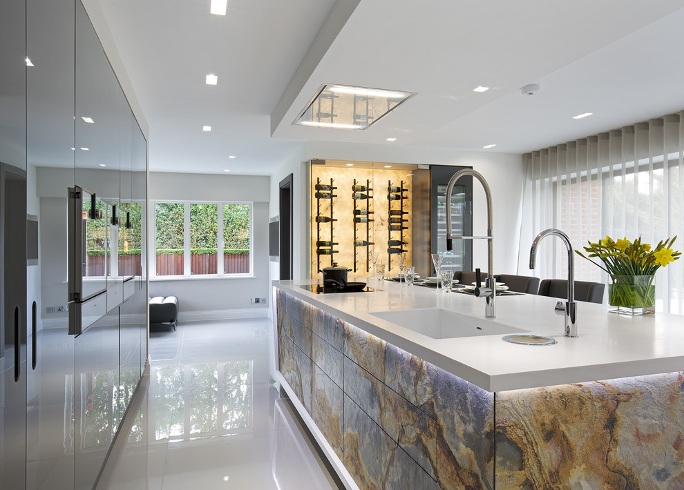 Ispirazione per una grande cucina contemporanea con lavello integrato, ante di vetro, ante grigie, top in superficie solida e pavimento in gres porcellanato