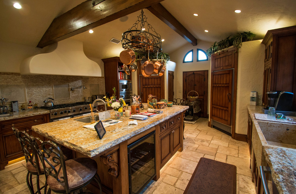 Example of a large southwest galley ceramic tile kitchen pantry design in Los Angeles with a drop-in sink, beaded inset cabinets, medium tone wood cabinets, granite countertops, beige backsplash, ceramic backsplash, stainless steel appliances and an island