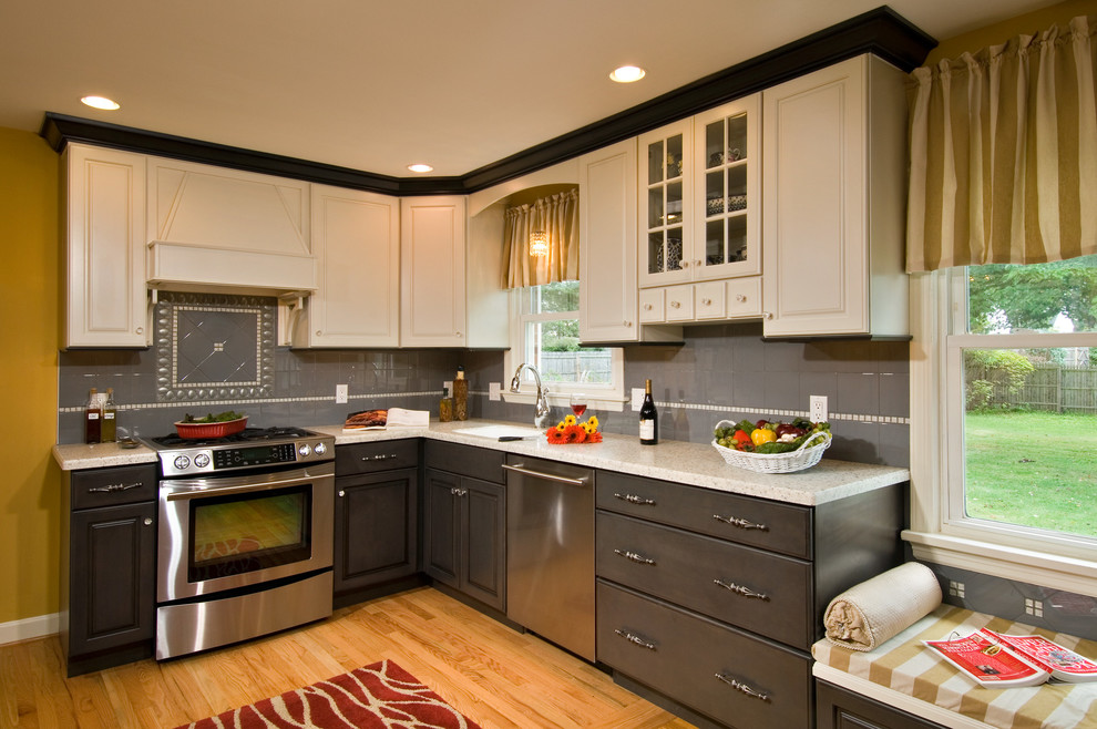 Photo of a traditional kitchen in Boston with raised-panel cabinets, grey splashback and stainless steel appliances.