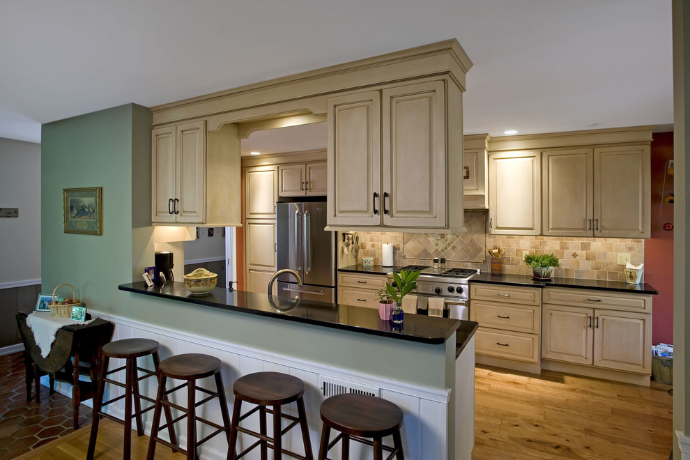 Mid-sized elegant galley light wood floor eat-in kitchen photo in Philadelphia with an undermount sink, distressed cabinets, multicolored backsplash, stainless steel appliances and no island