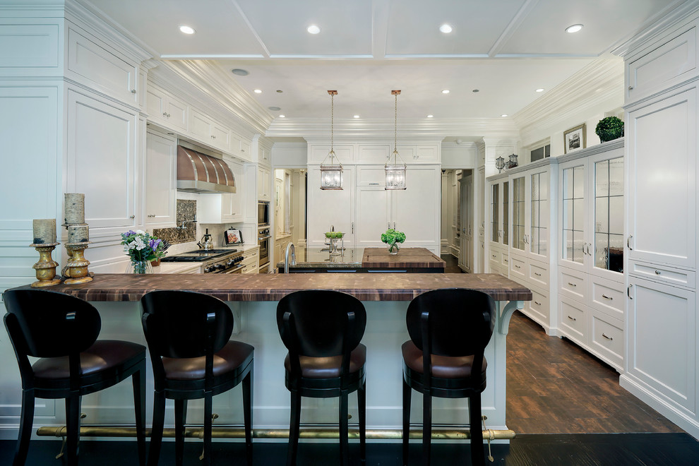 Huge elegant u-shaped dark wood floor eat-in kitchen photo in Chicago with an undermount sink, stainless steel appliances, an island, shaker cabinets, white cabinets, marble countertops, white backsplash and stone slab backsplash