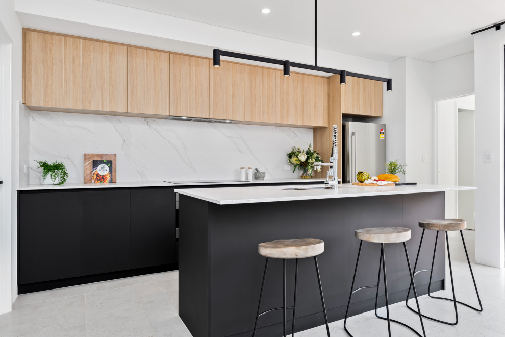 Photo of a medium sized scandinavian galley kitchen in Perth with a submerged sink, flat-panel cabinets, black cabinets, white splashback, stainless steel appliances, porcelain flooring, an island, grey floors and white worktops.