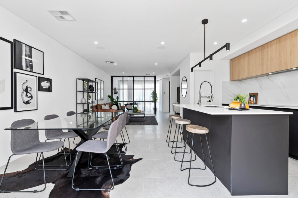 This is an example of a large scandinavian galley open plan kitchen in Perth with a submerged sink, flat-panel cabinets, black cabinets, white splashback, stainless steel appliances, an island, white floors and white worktops.